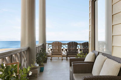 chairs on porch looking at beach and ocean